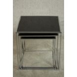 A contemporary nest of three occasional tables. glass and chrome, with dark glass inserts on chromed