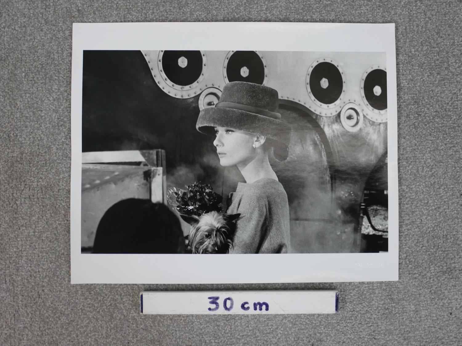 A black and white photo of Audrey Hepburn holding a dog in a smart hat by Hulton Archive. - Image 3 of 4