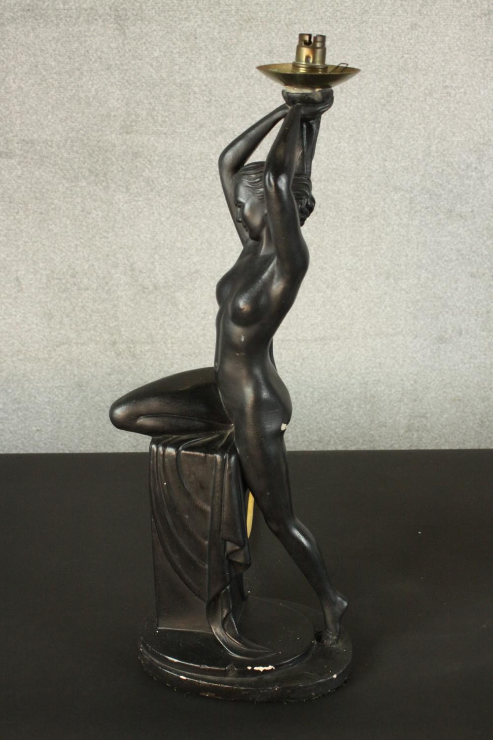 An Art Deco style black painted plaster table lamp in the form of a nude dancer perched on a - Image 2 of 6