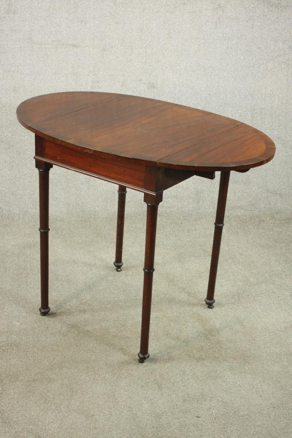 A mahogany drop leaf Pembroke style table, the oval top with a crossbanded edge, on turned legs. H. - Image 5 of 10