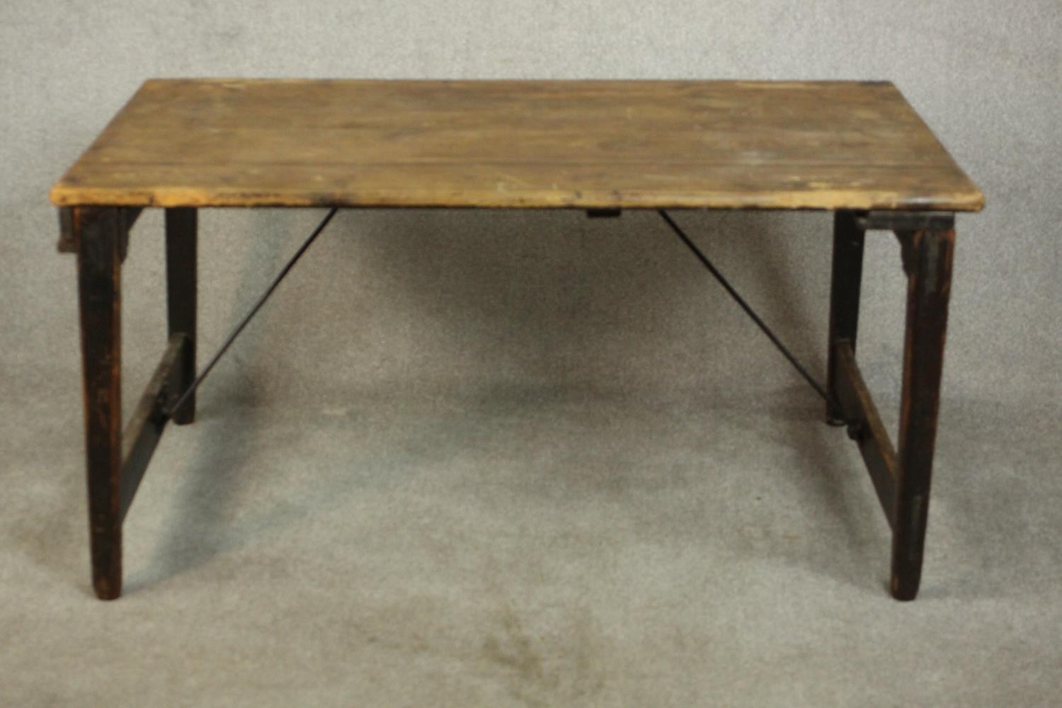 A pine folding trestle table, with a rectangular plank top on folding end supports. H.68 W.136 D. - Image 5 of 8