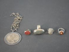 A collection of silver rings and jewellery, including a silver The Principality of Elba under