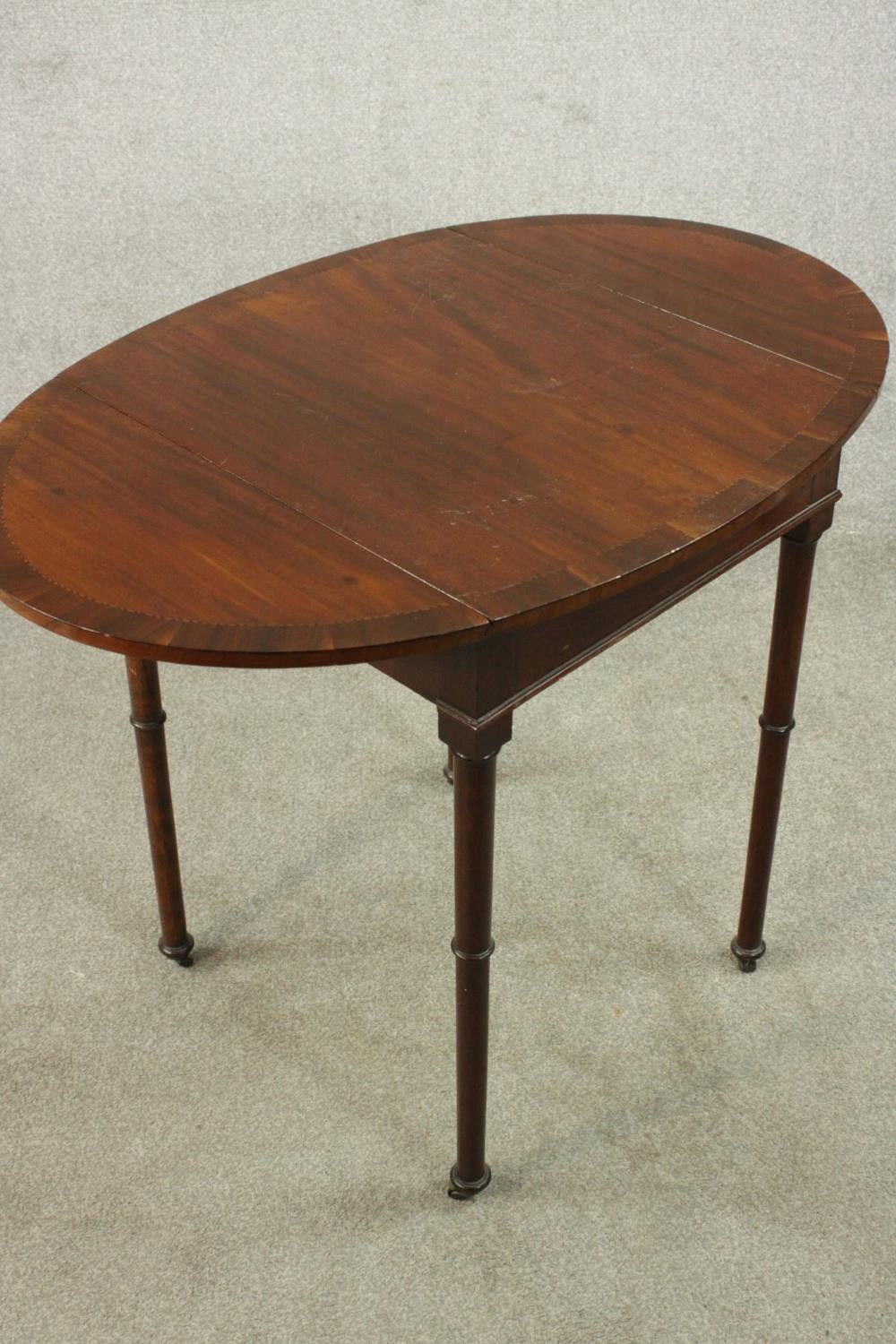 A mahogany drop leaf Pembroke style table, the oval top with a crossbanded edge, on turned legs. H. - Image 8 of 10