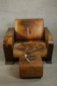 A Heal's style Art Deco brown leather armchair with integral book shelves to the side and rear,