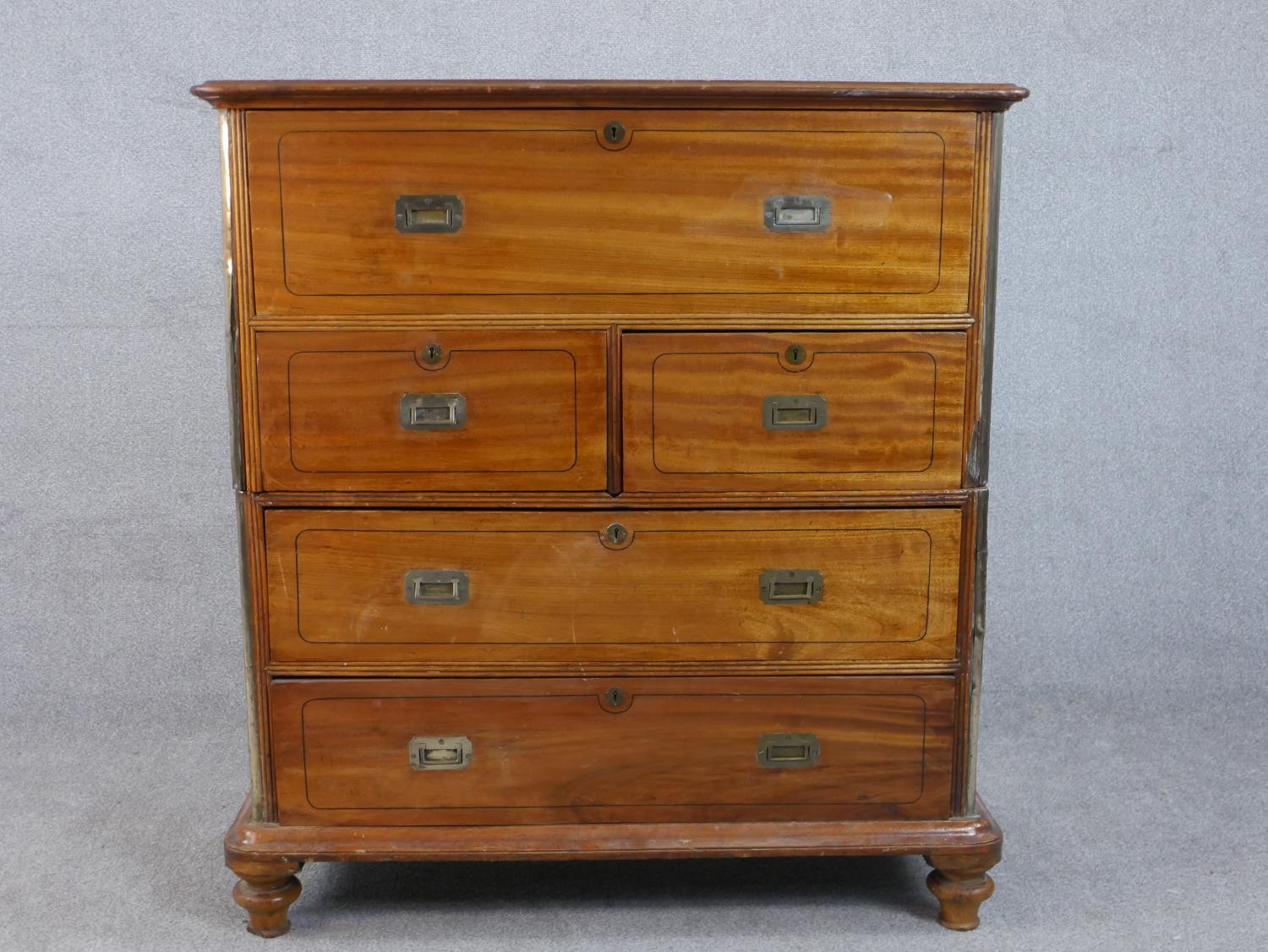 A 19th century camphorwood secretaire campaign chest, in two sections, with a secretaire drawer