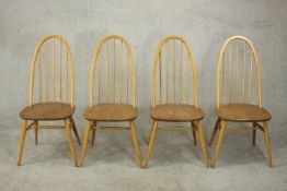 A set of four Ercol hoop back Quaker dining chairs with makers label to underside.