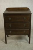 An early 20th century oak chest, with a gallery back over three long drawers, on square section