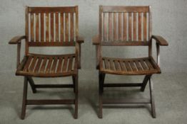 A pair of contemporary John Lewis teak folding garden armchairs, with maker's label.