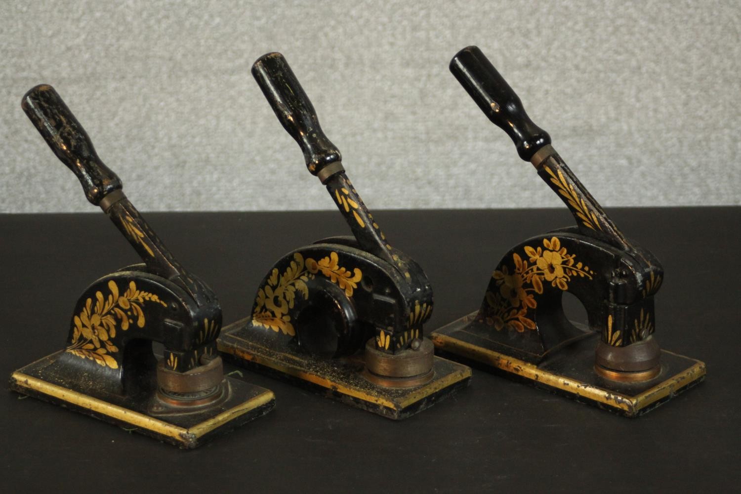 Three Victorian T. H. Marriot gilded iron paper presses, each decorated with a floral and foliate