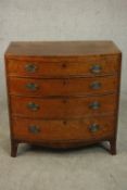 A George III mahogany bow front chest of small proportions, with four long graduated drawers, over a