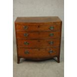 A George III mahogany bow front chest of small proportions, with four long graduated drawers, over a