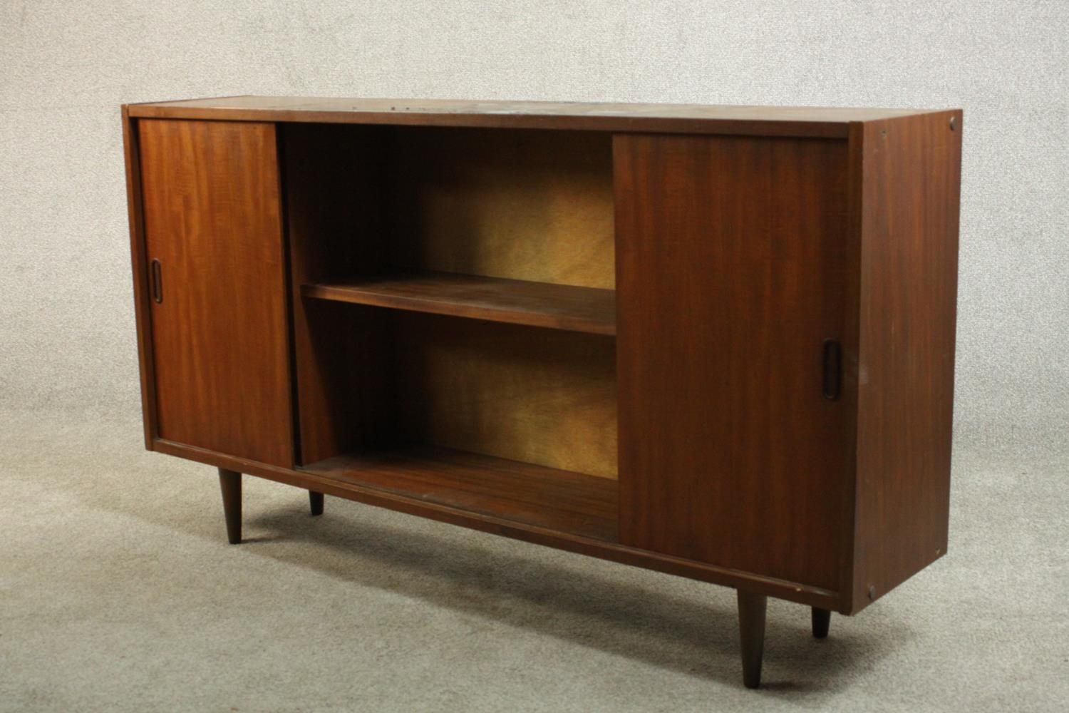 A circa 1960s teak sideboard, fitted with shelves and two sliding doors, on tapering cylindrical - Image 6 of 8