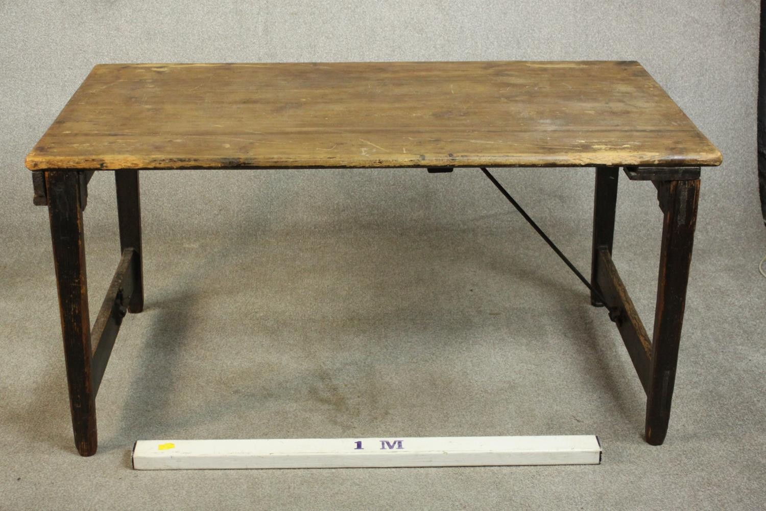 A pine folding trestle table, with a rectangular plank top on folding end supports. H.68 W.136 D. - Image 2 of 8