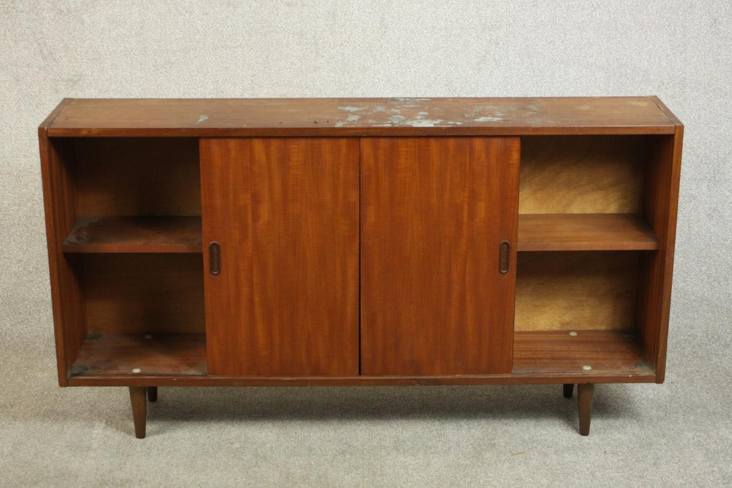 A circa 1960s teak sideboard, fitted with shelves and two sliding doors, on tapering cylindrical - Image 3 of 8