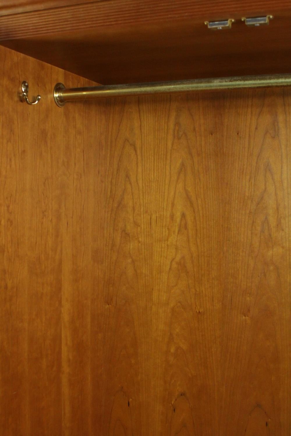 A late 20th century cherrywood wardrobe, with a pair of panelled doors opening to reveal hanging - Image 9 of 13