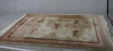 A fawn ground hand made Chinese carpet with Foo dogs. L.225 W.167cm