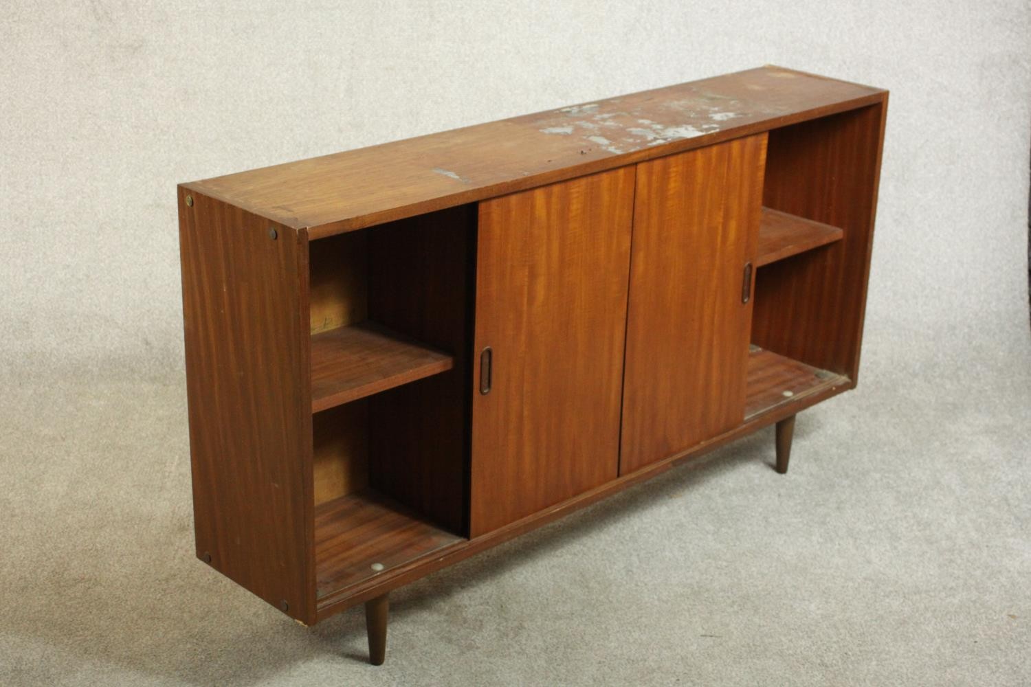 A circa 1960s teak sideboard, fitted with shelves and two sliding doors, on tapering cylindrical - Image 4 of 8