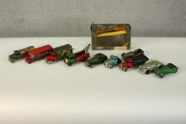 A collection of eleven vintage tin plate and die cast toy vehicles, including trucks, cars and