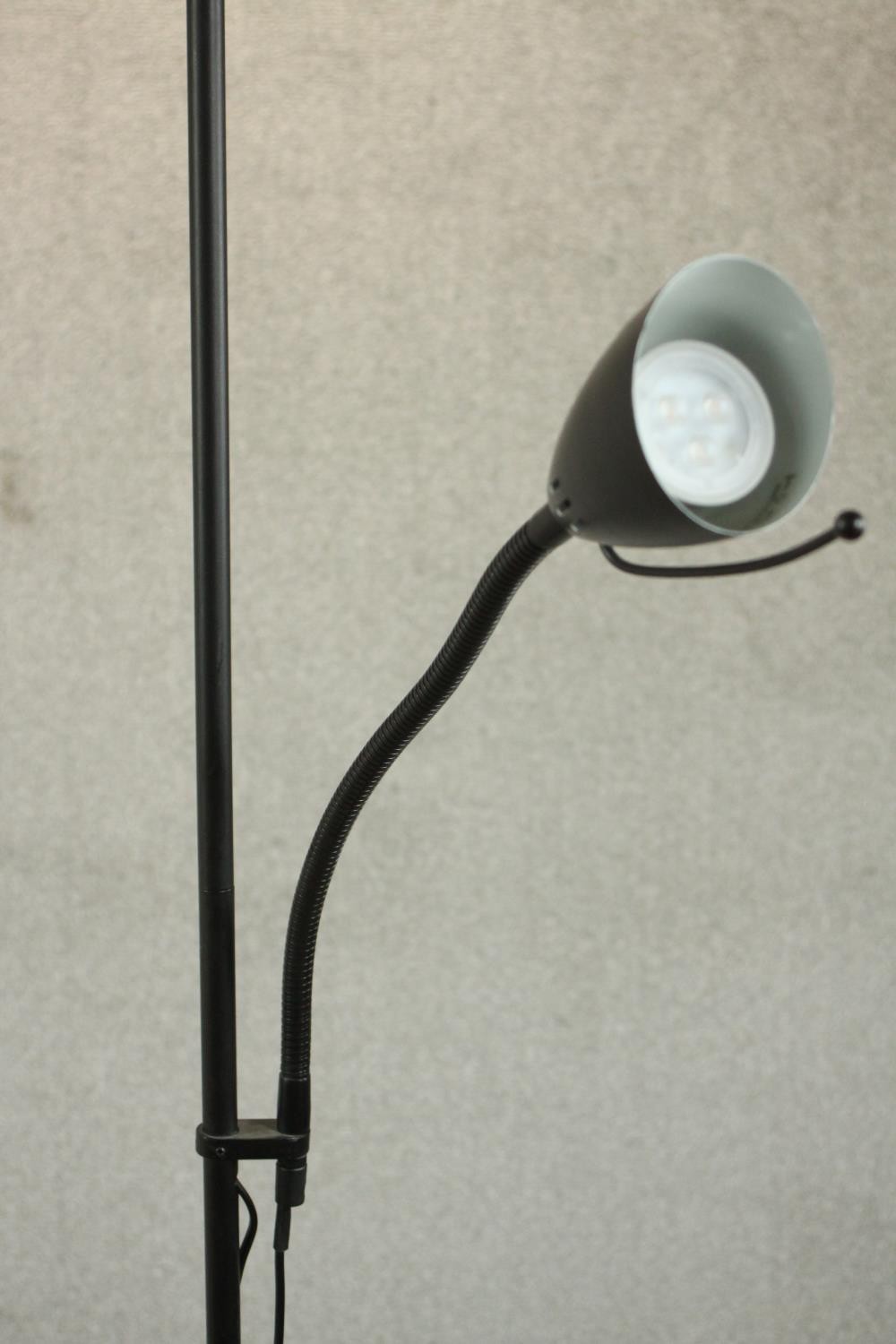 A contemporary ebonised uplighter and reading lamp, the reading lamp on an adjustable arm, on a - Image 6 of 7