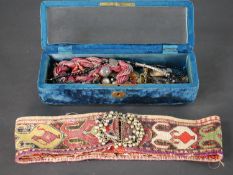 A blue velvet boxed collection of tribal and ethnic jewellery and a tapestry belt with mosaic