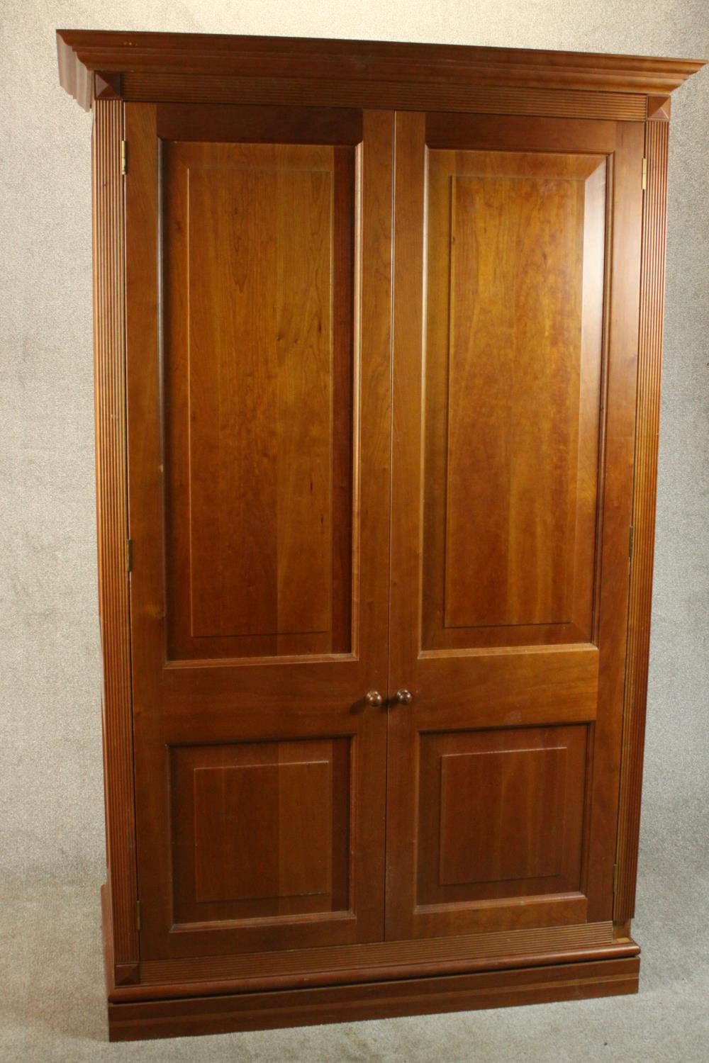 A late 20th century cherrywood wardrobe, with a pair of panelled doors opening to reveal hanging - Image 4 of 13