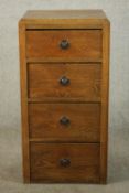 An early 20th century oak bedside chest of four drawers. H.91 W.46 D.42cm.