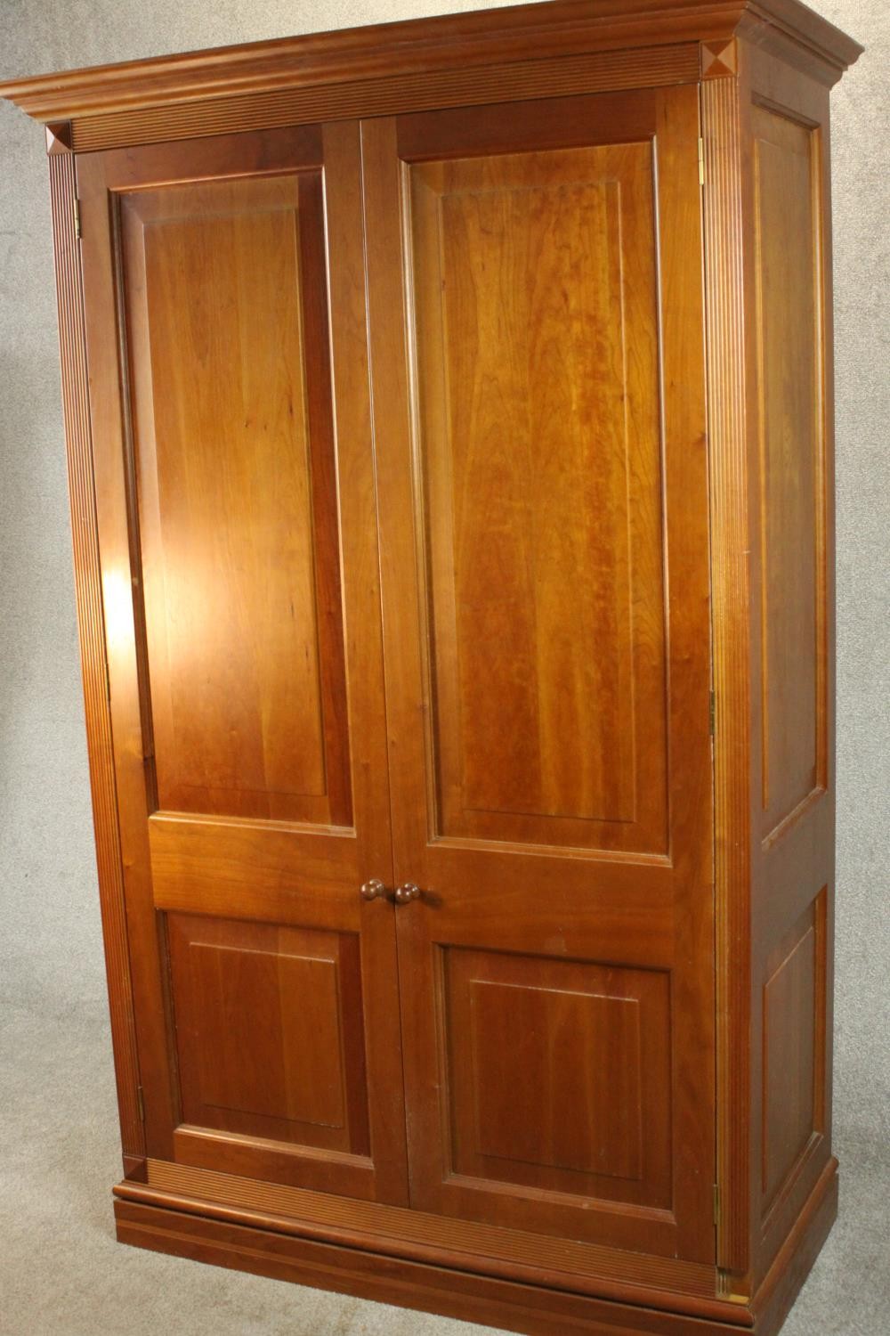 A late 20th century cherrywood wardrobe, with a pair of panelled doors opening to reveal hanging - Image 3 of 13