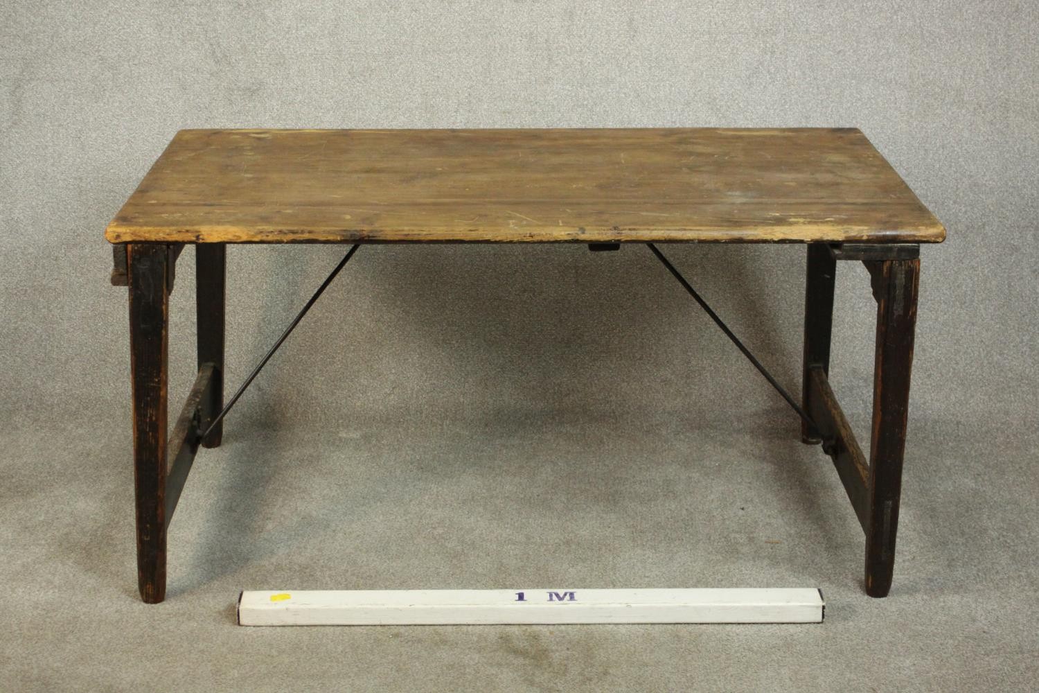 A pine folding trestle table, with a rectangular plank top on folding end supports. H.68 W.136 D. - Image 6 of 8