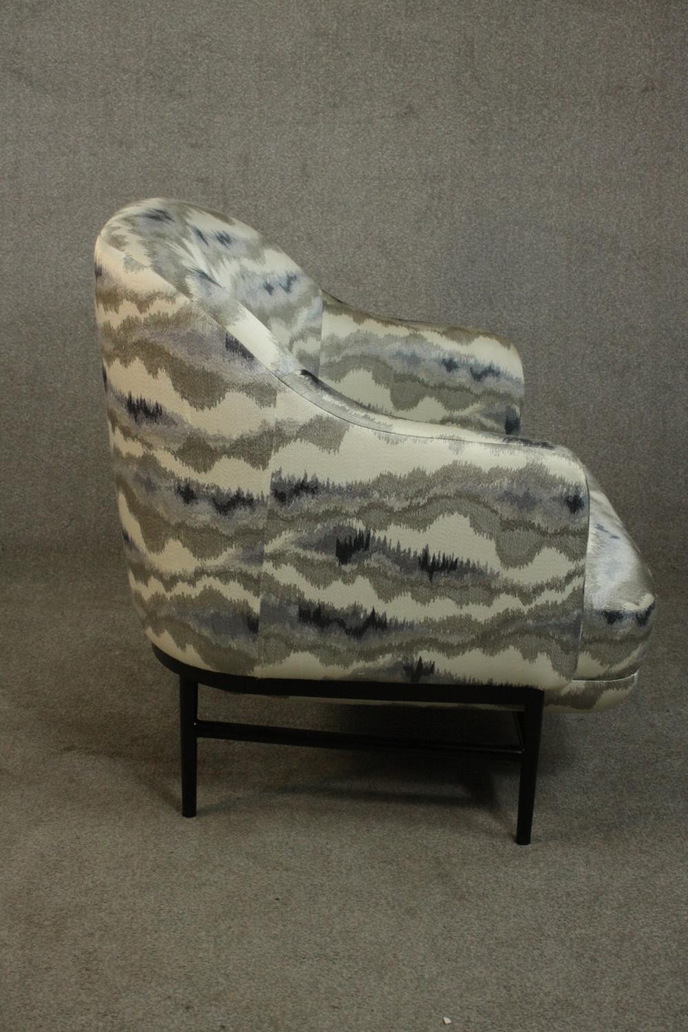 A pair of retro styled armchairs, with patterned upholstery in hues of grey, on a black powder - Image 12 of 13
