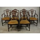 A set of six Hepplewhite style mahogany shield back dining chairs, comprising two carvers and four