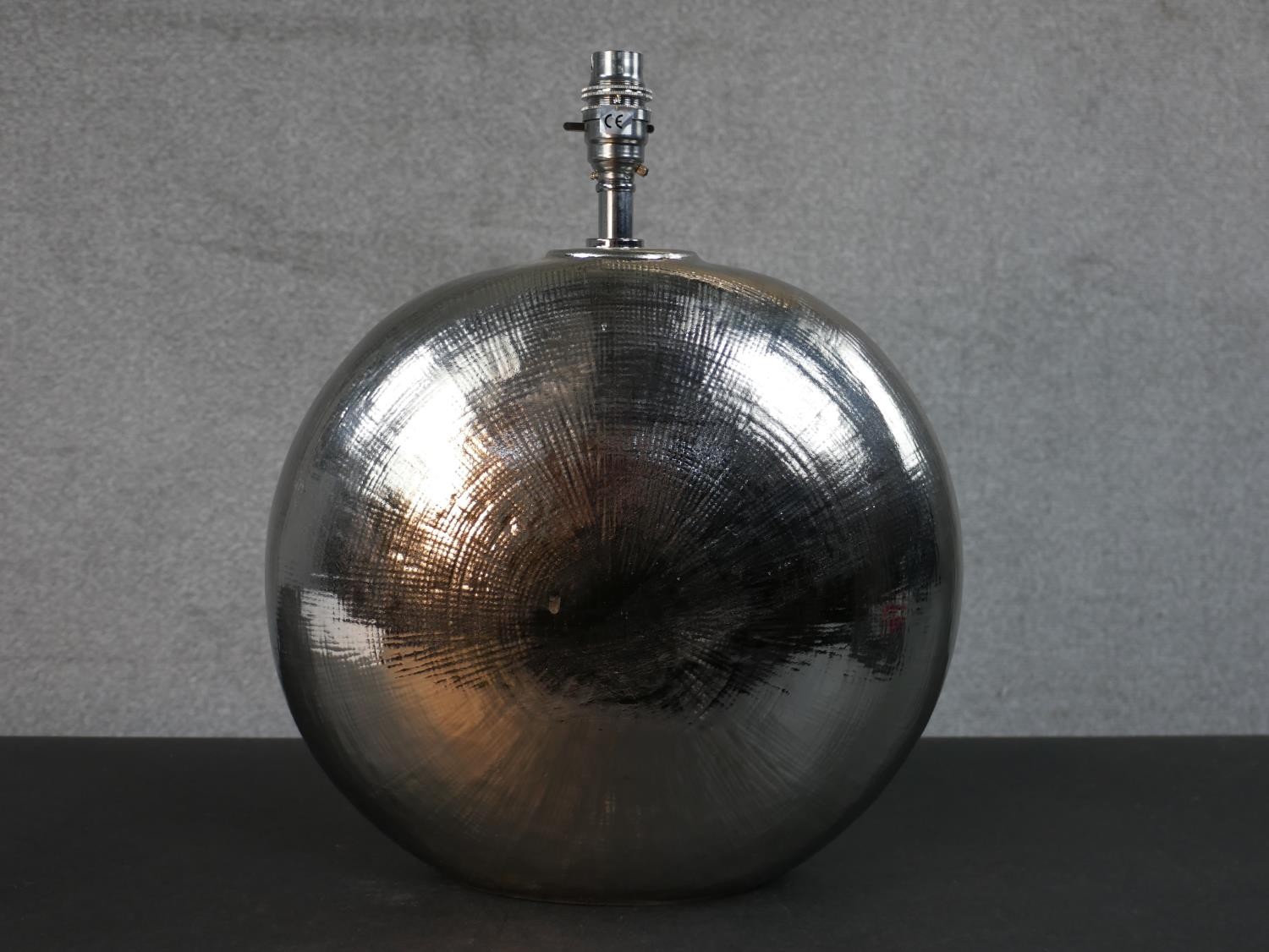 A bronze glazed spherical disc ceramic table lamp. H.38 W.31cm