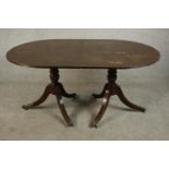 A George III style mahogany D end dining table, with an additional leaf, on turned supports with