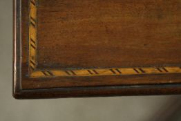 A late 19th century mahogany two tier occasional table, the top with an inlaid border, over a long