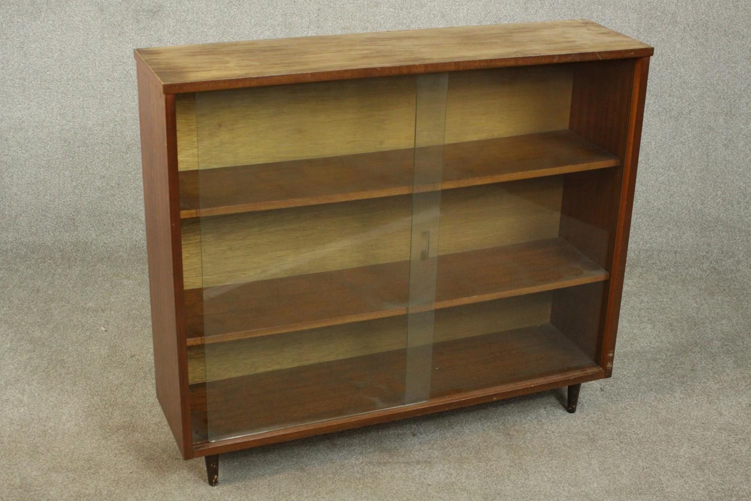 A circa 1960s Jonell bookcase, with a pair of glass sliding doors enclosing shelves, on tapering - Image 4 of 7