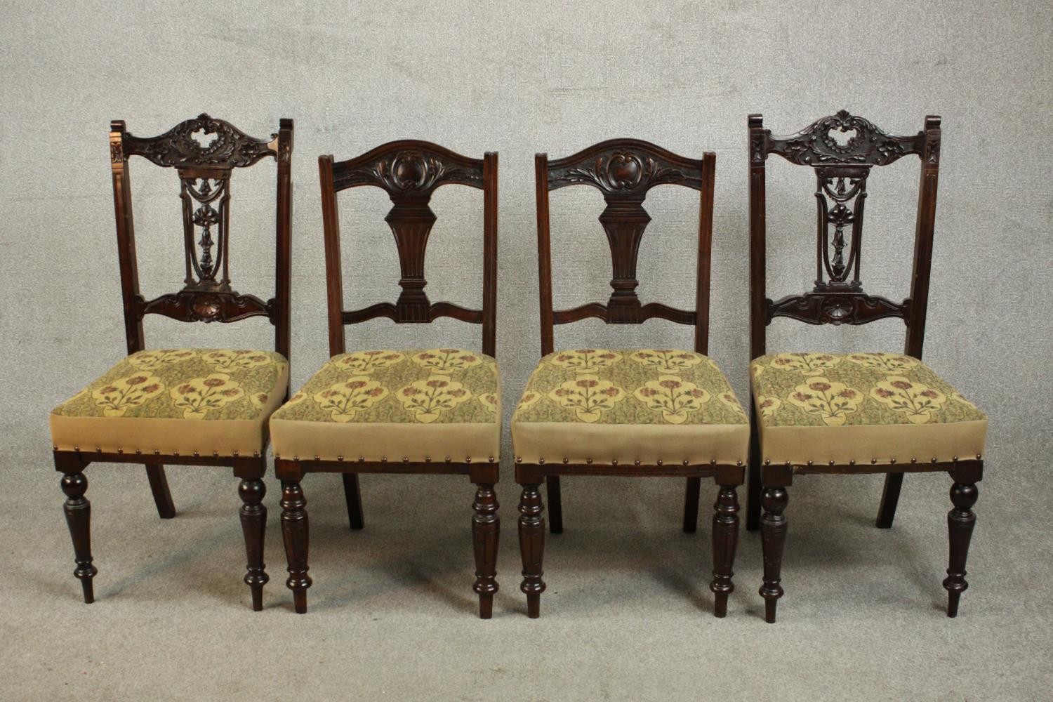 A harlequin set of four late Victorian walnut dining chairs, comprising two pairs of dining chairs