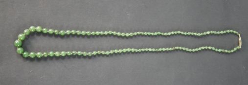 An antique gradated knotted jade bead necklace with hook and push clasp. The necklace contains 111