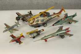 A collection of seven vintage Japanese and Chinese tin plate aircraft. Various makers. H.12 W.38 D.