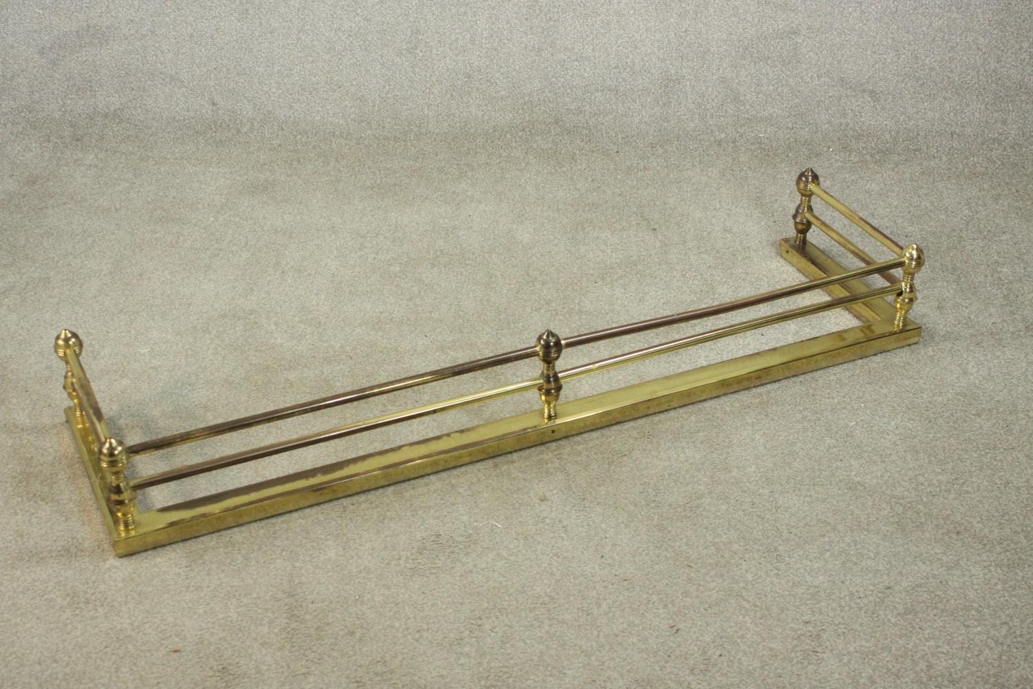 A Victorian brass fender of typical form with ball supports to the tubular rails. H.18 W.134 D.36cm. - Image 3 of 5