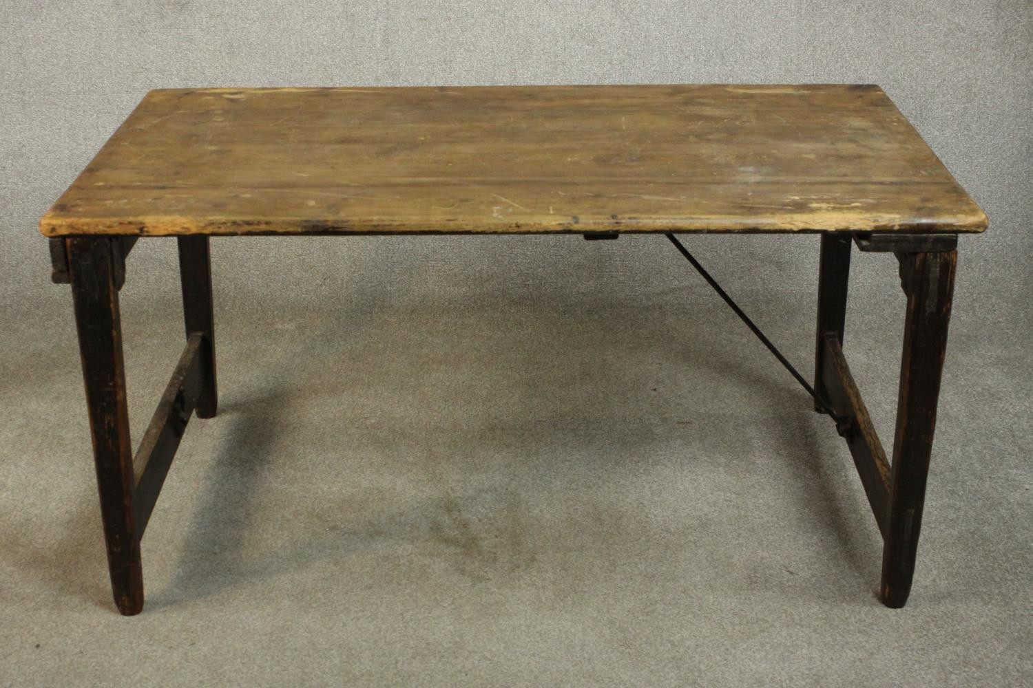 A pine folding trestle table, with a rectangular plank top on folding end supports. H.68 W.136 D.