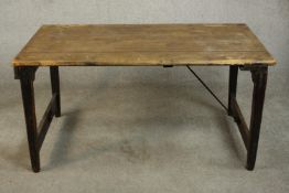 A pine folding trestle table, with a rectangular plank top on folding end supports. H.68 W.136 D.