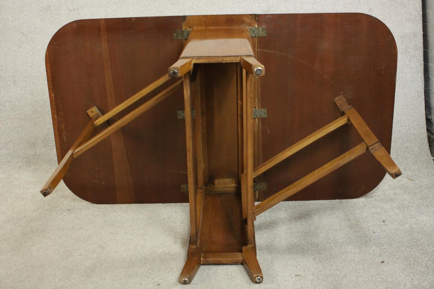 A mid 20th century walnut drop leaf dining table, the two leaves with rounded corners on a base with - Image 9 of 9