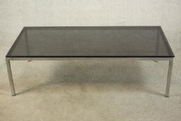 A 1970's coffee table, of rectangular form with a smoked plate glass top on a chromed steel base.