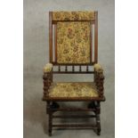 A late 19th / early 20th century American walnut rocking chair, upholstered in tapestry style floral