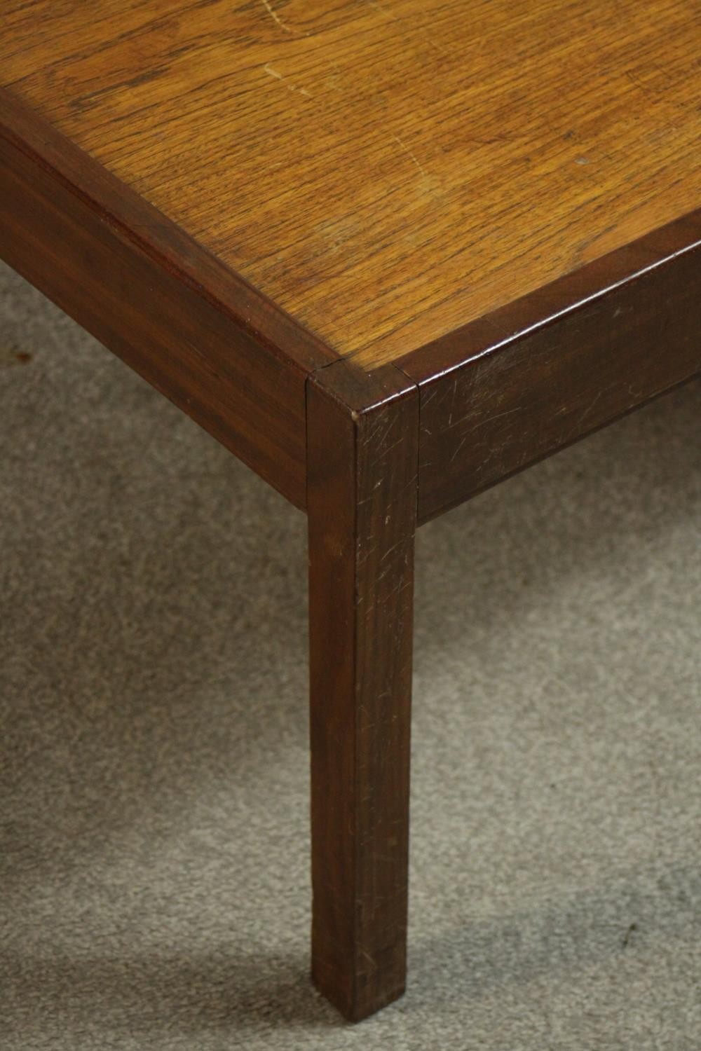 A circa 1960s teak and mahogany coffee table of square form. H.38 W.82cm. - Image 6 of 6