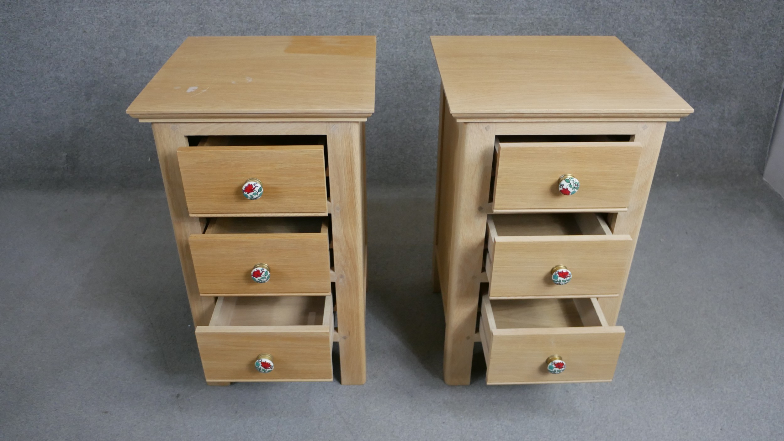 A pair of contemporary oak bedside chests each with three drawers and painted floral handles. H.73 - Image 2 of 4