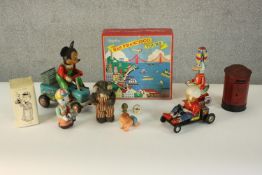 A collection of ten vintage tin plate toys, and boxed toy amusement park. Various makers. H.9 W.25