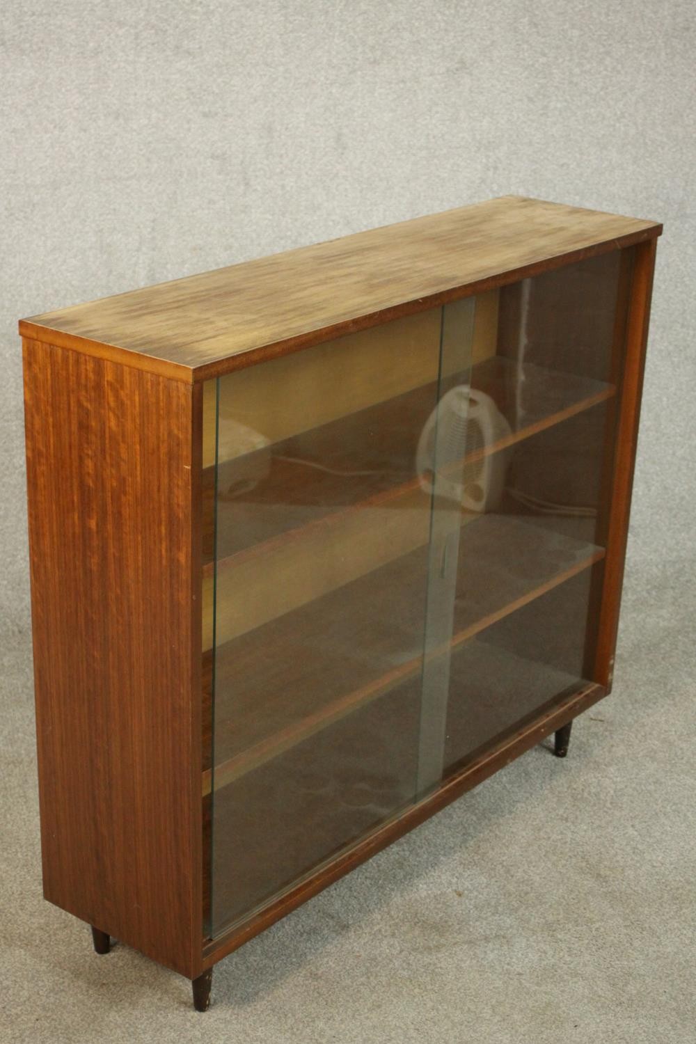 A circa 1960s Jonell bookcase, with a pair of glass sliding doors enclosing shelves, on tapering - Image 5 of 7