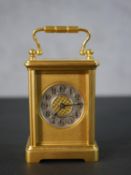 A late Victorian gilt brass cased carriage clock, circular chapter ring with, numerals, the gilt