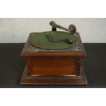 A Columbia oak Graphophone, with a winding arm and green baize turntable. H.27 W.40 D.40cm.
