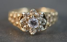 A 9 carat yellow gold and white metal diamond ring, set to centre with a round brilliant cut diamond